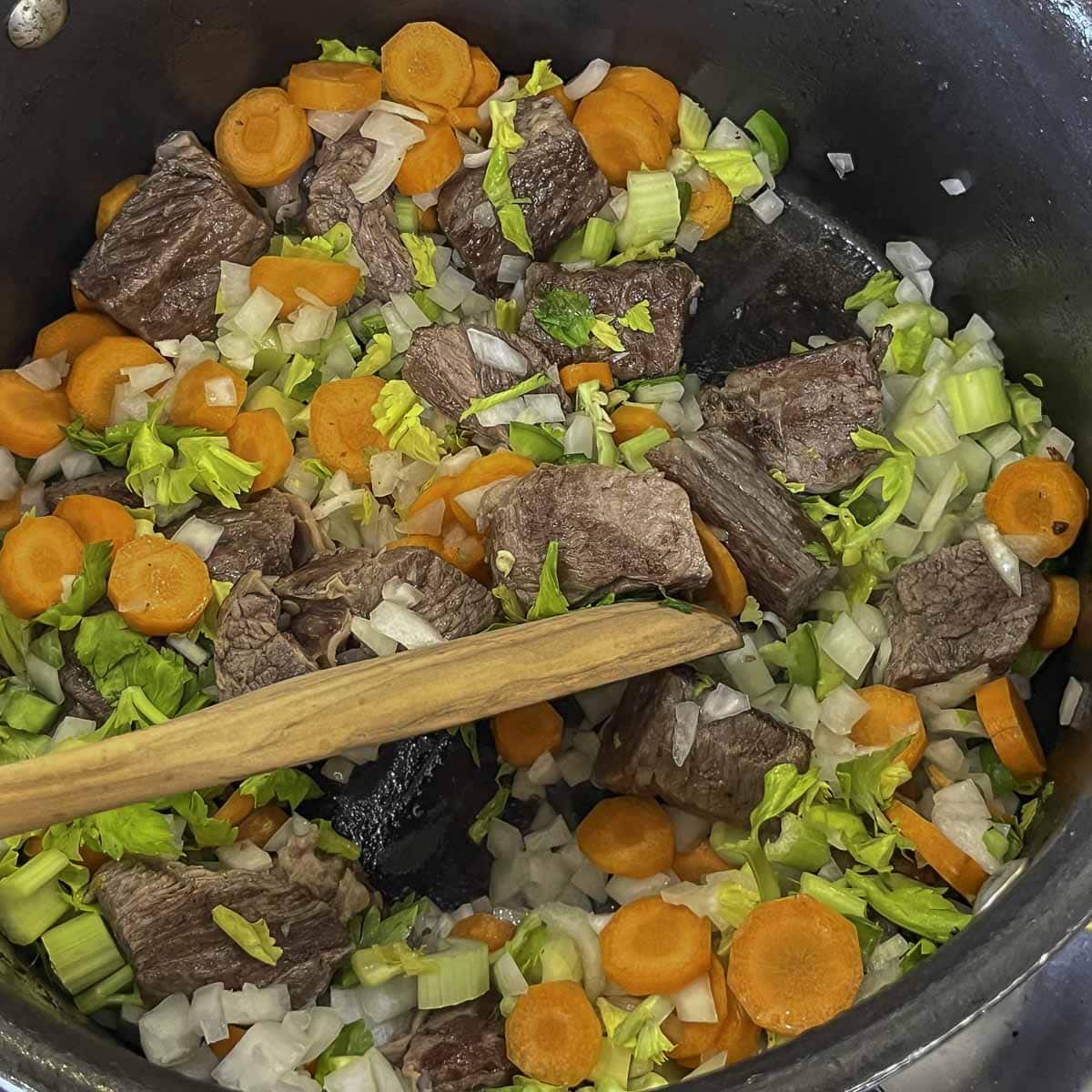 meat and veggies being sauteed 